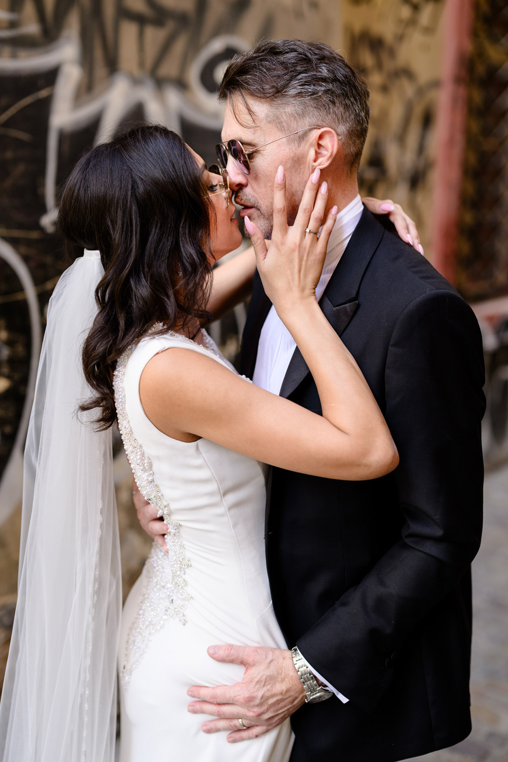 Bride and groom kissing in streets of Prague