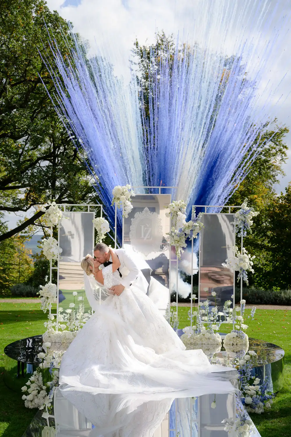 Wedding at Chateau Mcely - bride and groom share their first kiss with a spectacular blue and white firework display.